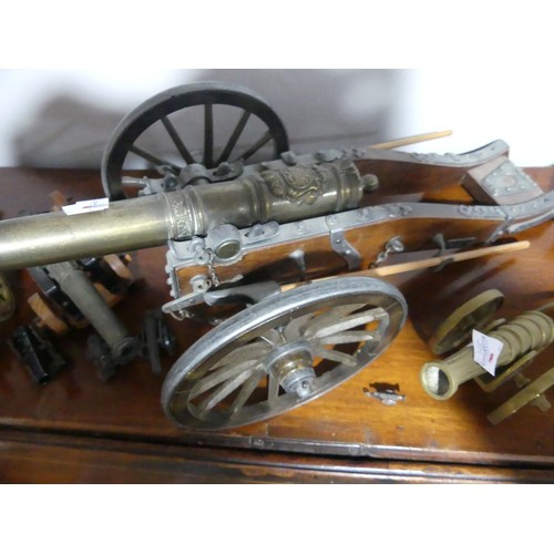 408 - A decorative cannon together with approx twenty more decorative smaller cannons, W18.5cm x H 18cm x ... 