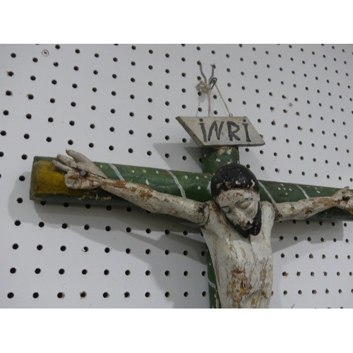 412 - A Guatemalan primitive handmade religious folk art wooden Crucifix, depicting Jesus on the cross, pa... 