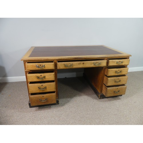 270 - An Edwardian oak twin Pedestal Desk, the tooled leather top above three frieze drawers with three fu... 