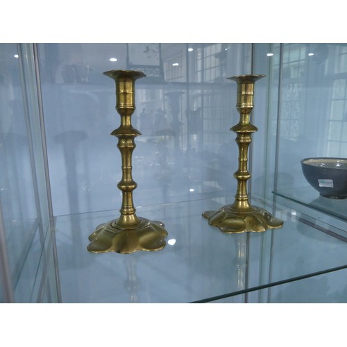 442 - A pair of George III brass Candlesticks, in the manner of William Lee of Birmingham, with lobed peta... 