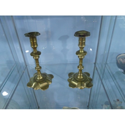 442 - A pair of George III brass Candlesticks, in the manner of William Lee of Birmingham, with lobed peta... 