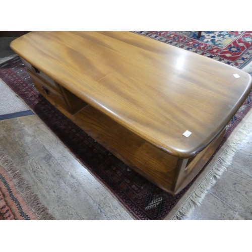 456 - An Ercol dark blonde Windsor Minerva Coffee Table, with two drawers and open display section, raised... 