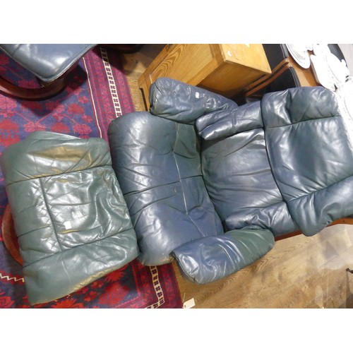 462 - A pair of Erkones Stressless leather Armchair, with matching footstools, the chair 72cm wide, worn (... 