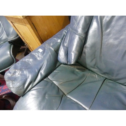 462 - A pair of Erkones Stressless leather Armchair, with matching footstools, the chair 72cm wide, worn (... 