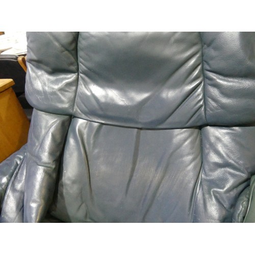 462 - A pair of Erkones Stressless leather Armchair, with matching footstools, the chair 72cm wide, worn (... 