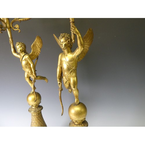 468 - A pair of late 19th century French gilt metal four branch figural Candelabra, the central cupid figu... 