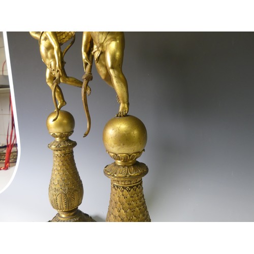 468 - A pair of late 19th century French gilt metal four branch figural Candelabra, the central cupid figu... 