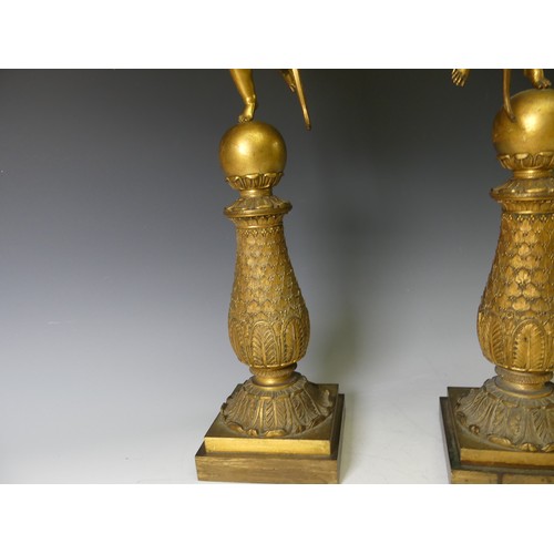 468 - A pair of late 19th century French gilt metal four branch figural Candelabra, the central cupid figu... 