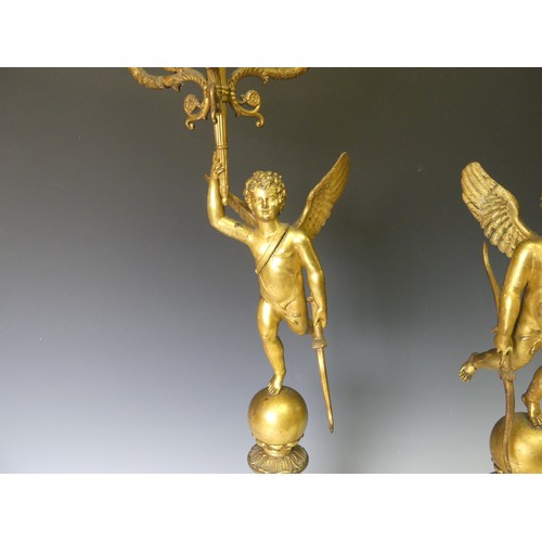 468 - A pair of late 19th century French gilt metal four branch figural Candelabra, the central cupid figu... 