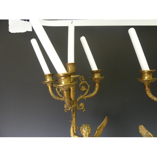 468 - A pair of late 19th century French gilt metal four branch figural Candelabra, the central cupid figu... 