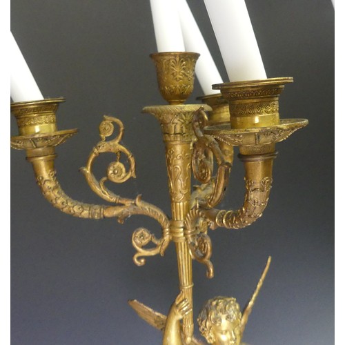 468 - A pair of late 19th century French gilt metal four branch figural Candelabra, the central cupid figu... 