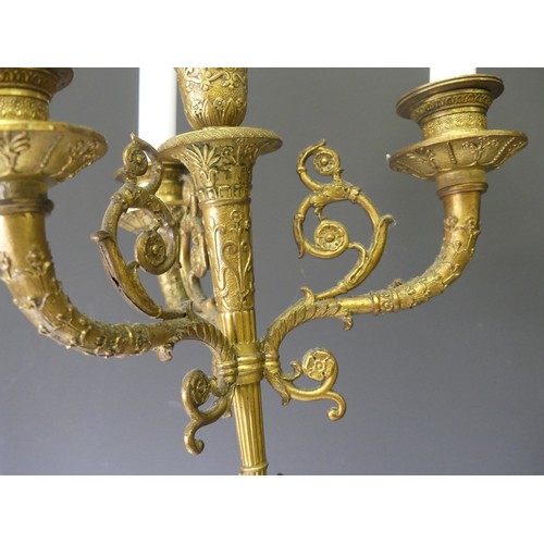 468 - A pair of late 19th century French gilt metal four branch figural Candelabra, the central cupid figu... 