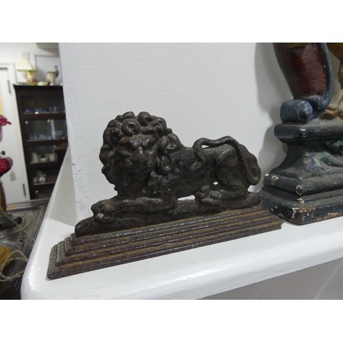 470 - A painted cast iron lion rampant Door Stop, 38cm high, together with three other small door stops; w... 