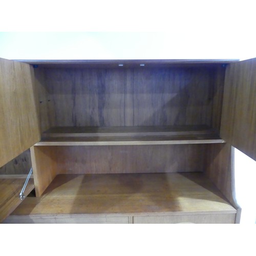 314 - A mid 20thC G-Plan 'Fresco' teak Sideboard, with two drawers, two drop down sections and a cupboard,... 