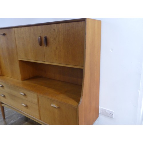 314 - A mid 20thC G-Plan 'Fresco' teak Sideboard, with two drawers, two drop down sections and a cupboard,... 