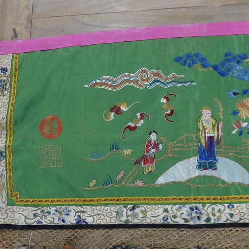 165 - Two early 20thC Chinese Silk Hangings: a green silk panel embroidered with figures in garden scene, ... 