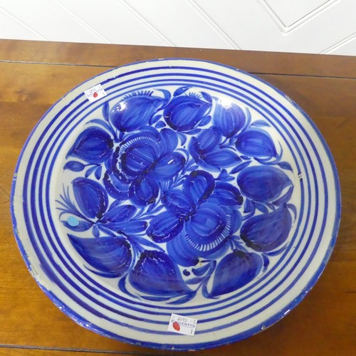 67 - A 19thC North European earthenware Charger, with blue and white decoration, chipped glaze around rim... 