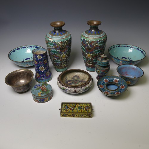 169 - A pair of oriental painted enamel Bowls, decorated in the famille rose palette with flowers on a pal... 