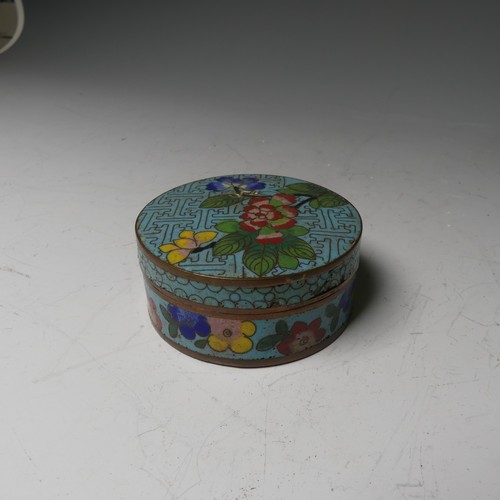 169 - A pair of oriental painted enamel Bowls, decorated in the famille rose palette with flowers on a pal... 