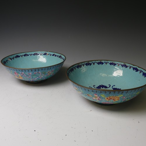 169 - A pair of oriental painted enamel Bowls, decorated in the famille rose palette with flowers on a pal... 