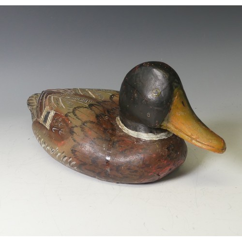 344 - A vintage carved and painted wooden Decoy Duck, modelled as a mallard, L 37cm, together with two oth... 