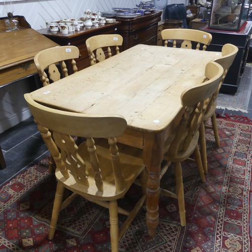 407 - A pine kitchen Table with six Chairs, only one frieze drawer present, W 136cm x H 77cm x D 76cm (tab... 