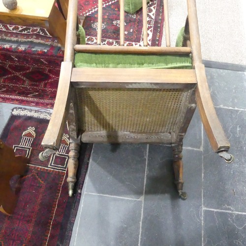 332 - A Victorian pitch pine framed Armchair, with stick back and scroll arms, upholstered green armrests,... 