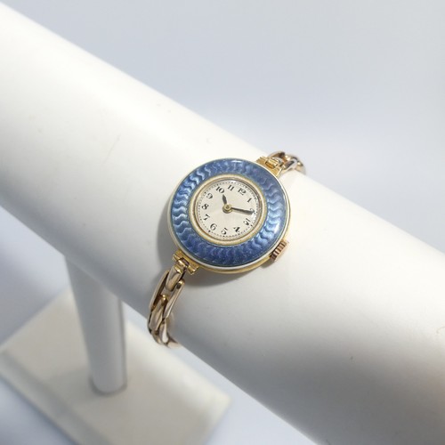 189 - An 18ct yellow gold lady's Wristwatch, with Swiss 15-jewels movement, the white enamel dial with Ara... 