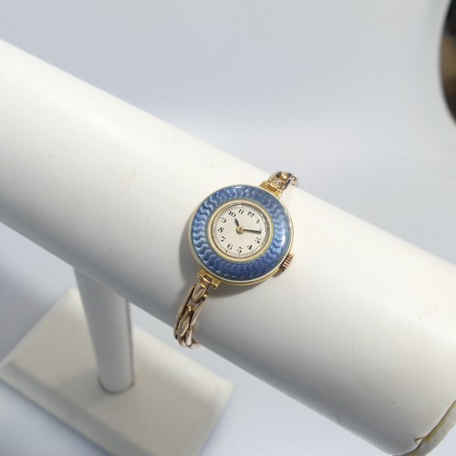 189 - An 18ct yellow gold lady's Wristwatch, with Swiss 15-jewels movement, the white enamel dial with Ara... 