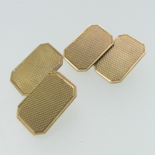 112 - A pair of 9ct gold Cufflinks, of rectangular form with canted corners and engine turned decoration, ... 