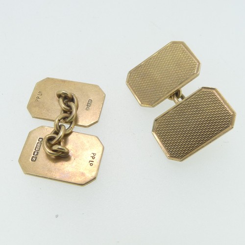 112 - A pair of 9ct gold Cufflinks, of rectangular form with canted corners and engine turned decoration, ... 