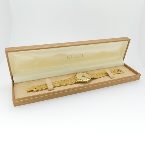 192 - A Gucci gold plated quartz Wristwatch, ref. 3300M, with gilt dial and integral bracelet, case no. 00... 