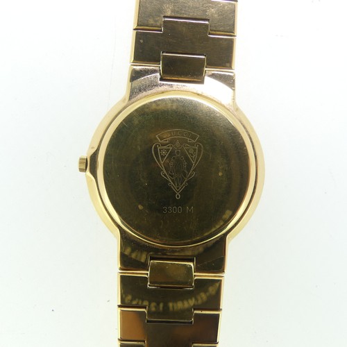 192 - A Gucci gold plated quartz Wristwatch, ref. 3300M, with gilt dial and integral bracelet, case no. 00... 