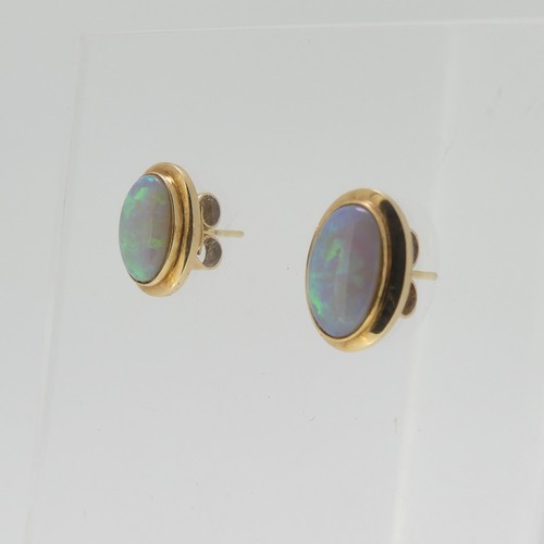 114 - A pair of opal Earrings, the oval stones approx. 11mm x 7mm collet set in unmarked yellow metal, tes... 