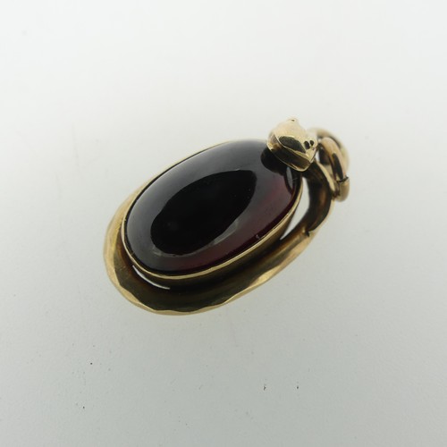 68 - A 19thC cabochon garnet Pendant, the unmarked mount in the form of a coiled snake, box and glass rev... 