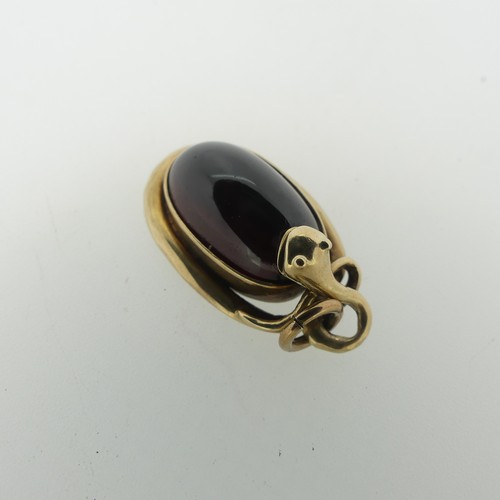 68 - A 19thC cabochon garnet Pendant, the unmarked mount in the form of a coiled snake, box and glass rev... 