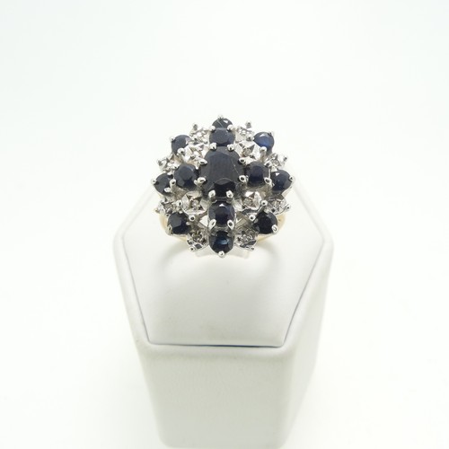 12 - A sapphire and diamond cluster Dress Ring, mounted in 9ct yellow and white gold, Size M, approx tota... 