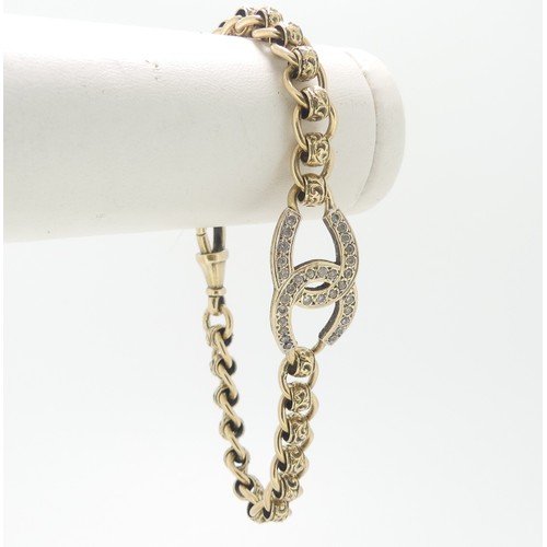 94 - A 9ct gold Bracelet, the front with paste set conjoined C's, watch clip fitting, 19cm long, total we... 