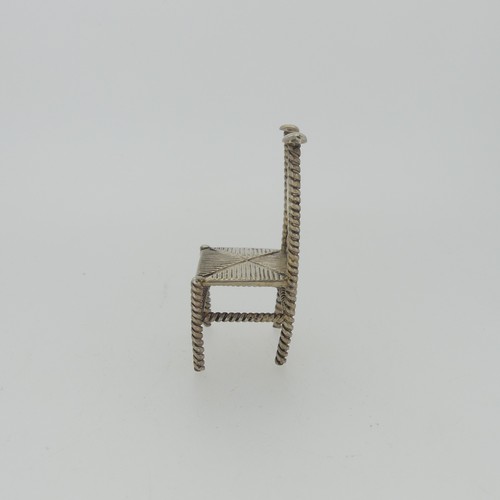 310 - A set of three Continental silver Chairs, with London hallmarks for 1903, 5cm high, together with a ... 