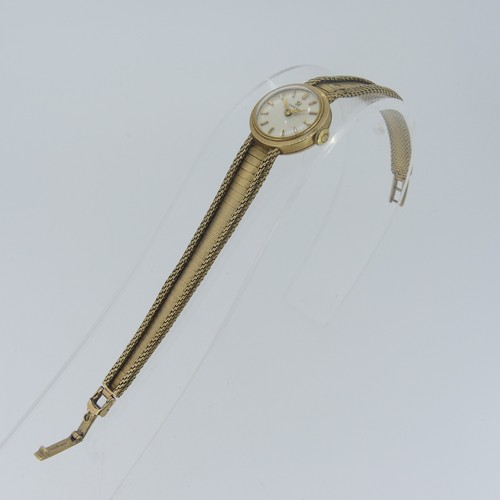 194 - An Omega 9ct gold lady's dress Wristwatch, the circular dial with gilt baton markers, on 9ct gold fl... 