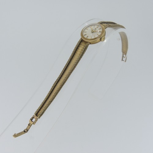 194 - An Omega 9ct gold lady's dress Wristwatch, the circular dial with gilt baton markers, on 9ct gold fl... 