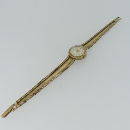 194 - An Omega 9ct gold lady's dress Wristwatch, the circular dial with gilt baton markers, on 9ct gold fl... 