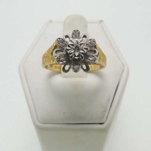 34 - A diamond cluster Ring, with illusion set diamonds in white gold, on textured 18ct yellow gold shoul... 