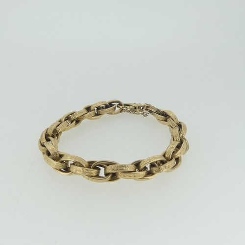 99 - A 9ct yellow gold Bracelet, by Uno-a-Erre, formed of engraved oval links, with clip fastening, 21cm ... 