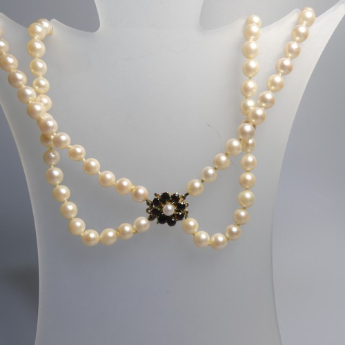 73 - A double row of uniform Cultured Pearls, with 9ct gold garnet cluster snap, 41cm long, together with... 