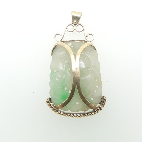 75 - A pierced jade Pendant, in unmarked yellow metal mount, tests as 9ct gold, the jade approx. 5cm x 3.... 