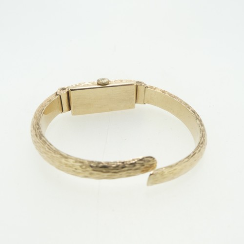 201 - A 9ct gold lady's Watch Bangle, with Swiss 17-jewels movement, the case and hinged bangle strap all ... 