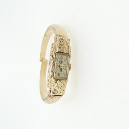 201 - A 9ct gold lady's Watch Bangle, with Swiss 17-jewels movement, the case and hinged bangle strap all ... 