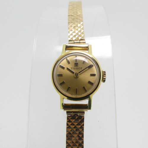 204 - A lady's Tissot Wristwatch, with champagne dial and baton markers, in a gold plated case with steel ... 