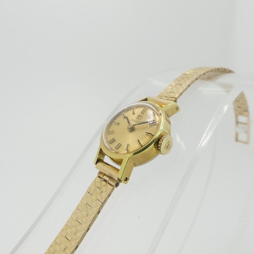 204 - A lady's Tissot Wristwatch, with champagne dial and baton markers, in a gold plated case with steel ... 